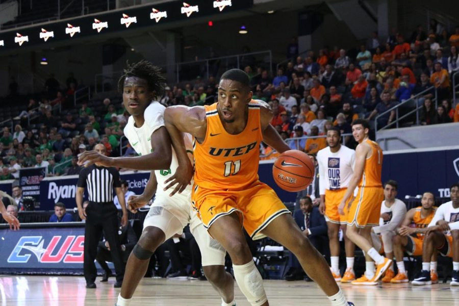 UTEP forward Bryson Williams pushes off defender as he looks for the score versus Marshall Feb. 15.