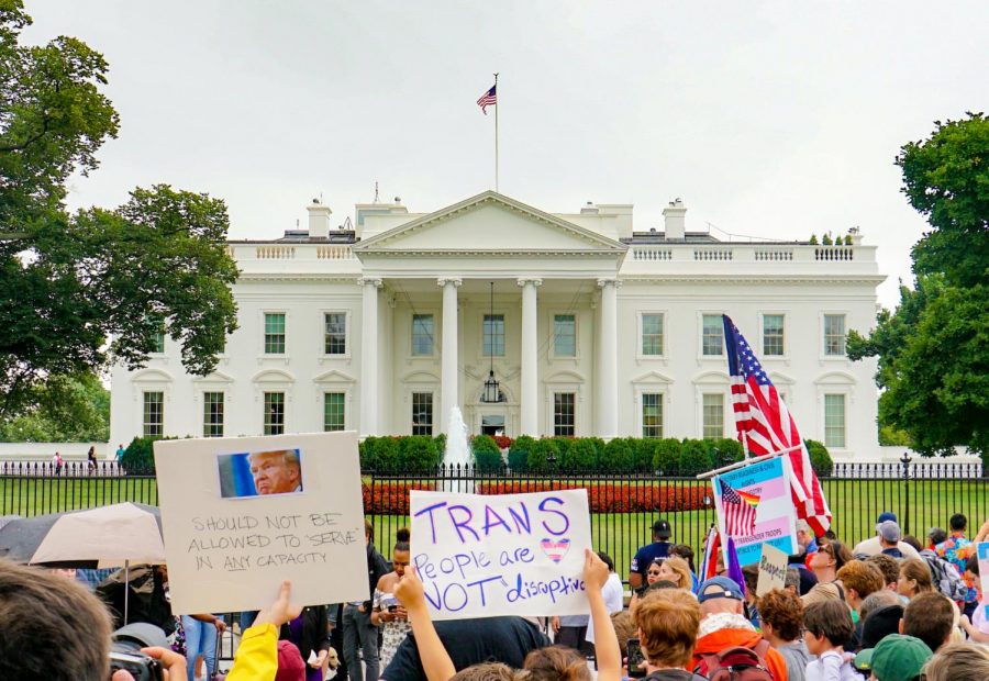 Protestors hold signs outside the White House, against former President Donald Trumps transgender military ban. This material is licensed to the public under the Creative Comm.