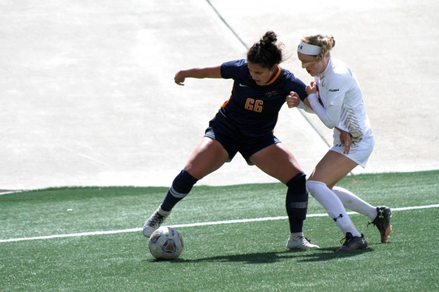 UTEP sophomore forward Tessa Carlin fights off a UAB defender near Blazer goal March 14.