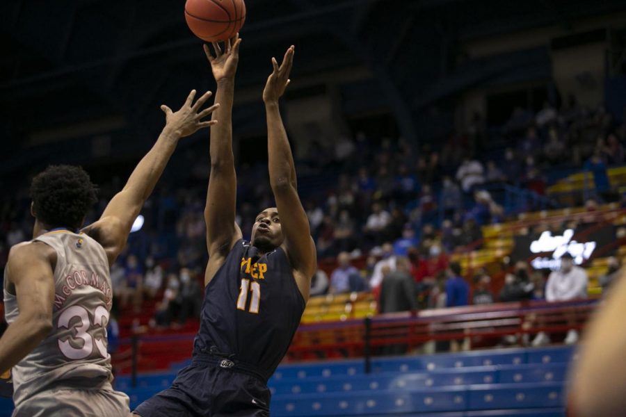 Senior forward Bryson Williams shoots a fade-away jumper over Kansass David McCormack March 4.