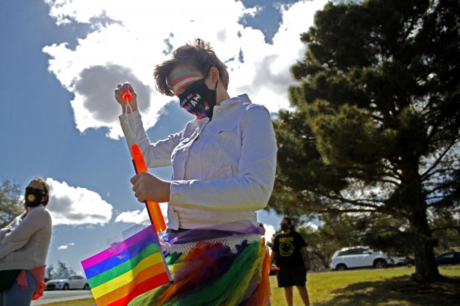 Cal Spencer plays with their friends at the Borderland Rainbow Centers rally in support of the transgender community on Saturday, March 27, 2021 at Memorial Park. 