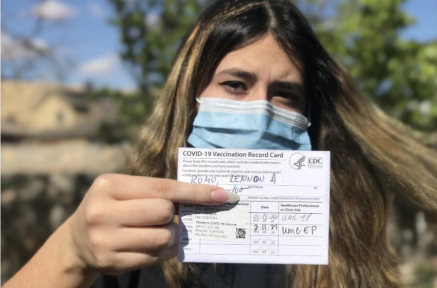 Photo+courtesy+of+Rene+Romo.%0ALennon+Romo+holds+her+COVID-19+Moderna+vaccine+record+card+while+wearing+a+mask.+Romo+received+her+second+dose+of+the+vaccine+on+Feb.+11%2C+2021%2C+as+part+of+the+Phase+1C+high+risk+group.