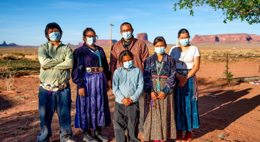 A+Navajo+family+stands+outside+its+home+with+face+masks+to+prevent+COVID-19+at+Monument+Valley%2C+Arizona.+