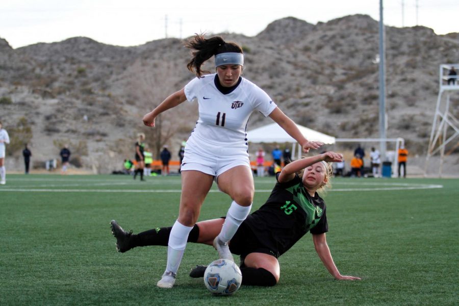 UTEP sophomore  midfielder Vanessa  Cabello fights off charge  from a Utah Valley defender as she moves downfield Feb. 13.