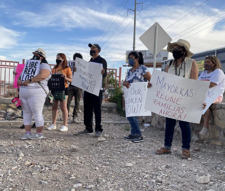Protesters hold signs during a rally at Jorge Almada Park across from Ft. Bliss  June 8, 2021.