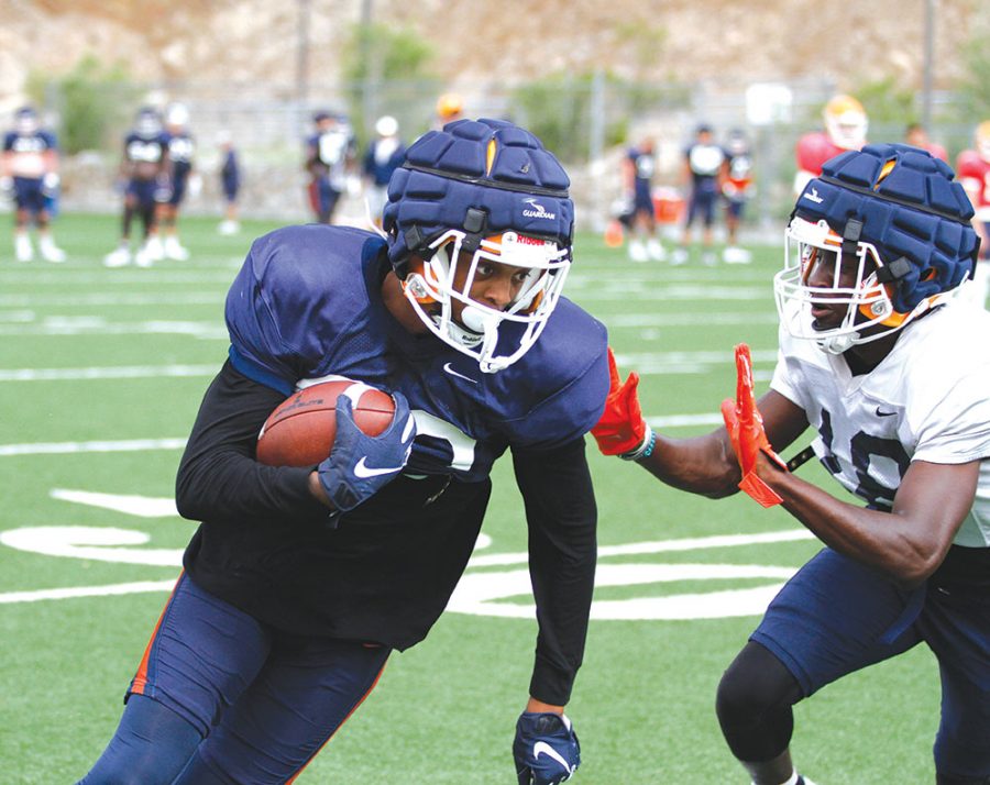 Luke Soto defends the quarterback from an oncoming defensive lineman during practice on August 16,2021 