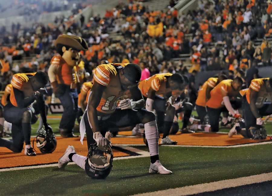 Safety Trejon Hugue kneels before the game against Louisiana Tech Oct. 16. 