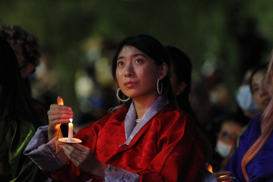 A Bhutanese student lights a candle in honor of President Emerita Dr. Natalicio at the Celebration of Life for President Emerita Diana Natalicio on Sunday, Oct. 24, at Centennial Plaza on the UTEP campus. 

 