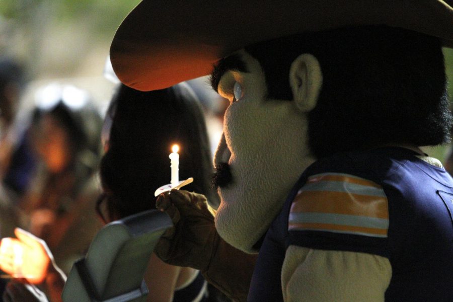 Paydirt Pete lights a candle in honor of President Emerita Dr. Natalicio at the Celebration of Life for President Emerita Diana Natalicio on Sunday, Oct. 24, at Centennial Plaza on the UTEP campus. 

 