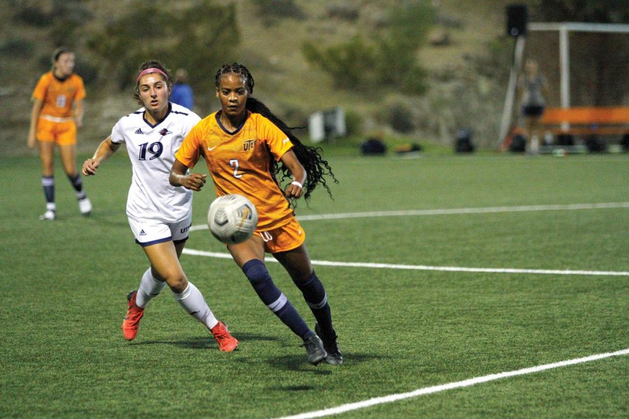 UTEP forward Kam Fisher prepares to pass the ball to a teammate against a UTSA opponent 