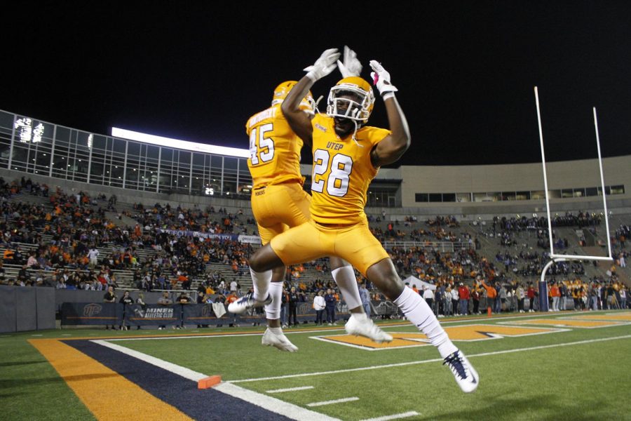 Defensive Back Darius Baptist chest bumps in the air with defensive end Quincy Montgomery on Nov. 6, 2021, at the Sun Bowl 