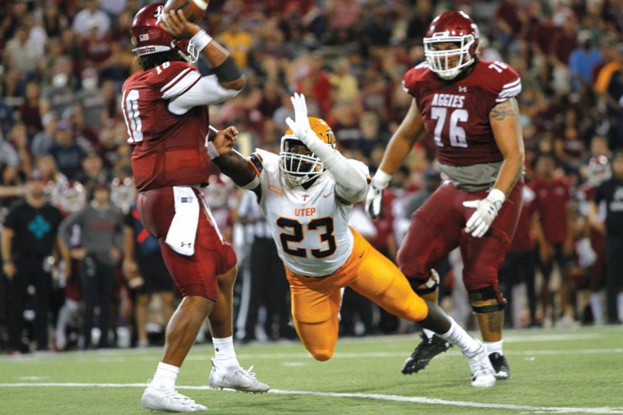 Praise Amaewhule lunges at the NMSU quarterback on Aug. 28, 2021 at Aggie Memorial Stadium.