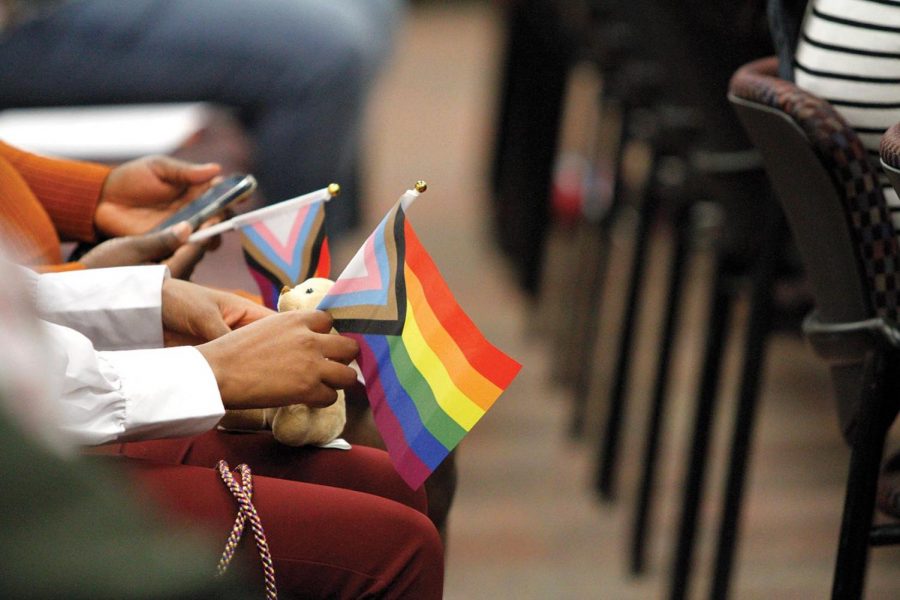 A graduating student holds pride flag in Rainbow Miner Graduation ceremony Nov. 19, 2021, at the Tomas Rivera Conference Center.