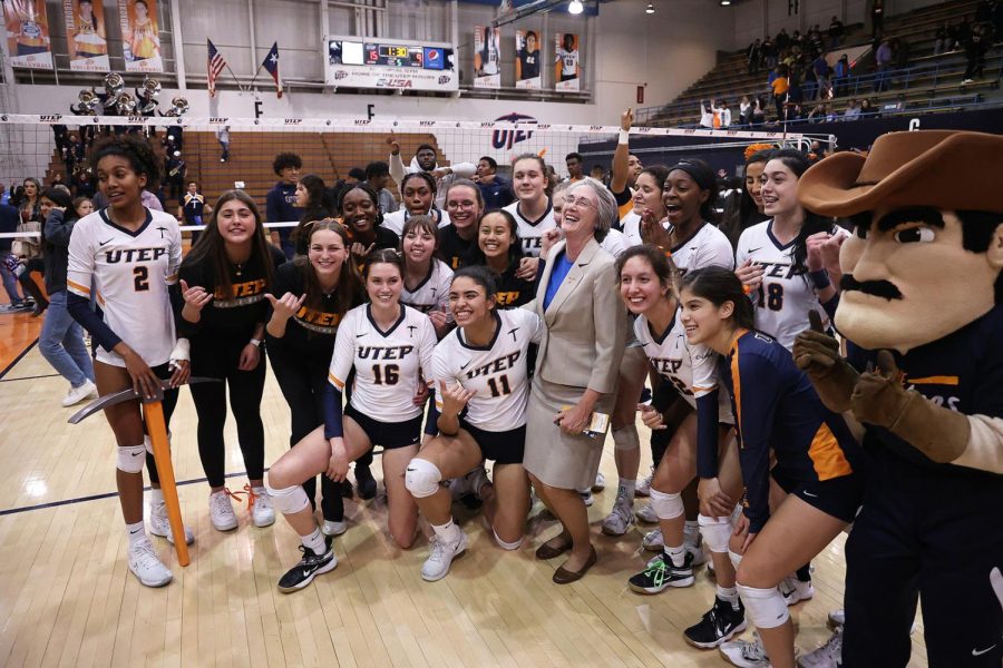 The UTEP volleyball team celebrates with UTEP President Heather Willson after winning against Webster State at UTEP Dec. 7 at Memorial Gym.  