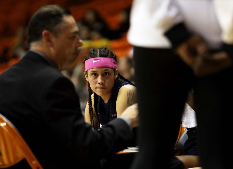 Guard Mahri Petree and the womens basketball team listen to Head Coach Kevin Baker during a time out against Louisiana Tech University at the Don Haskins Center Feb. 17. 