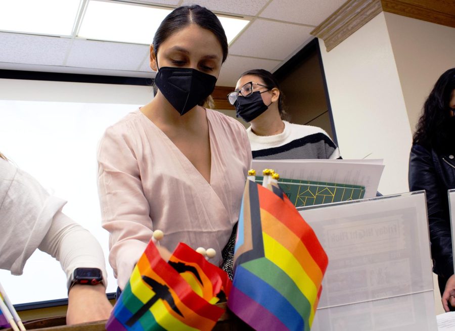 Anaysa Arce grabs to get her pins and flags from the LGBTQIA2S+ workshop on Wednesday, Feb. 9.  