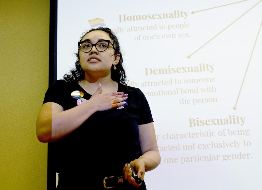 Lead speaker Daisy Marquez, leadership, inclusion, and advocacy coordinator for SELC, demonstrates the hand gesture for sexual orientation at the LGBTQIA2S+ workshop.