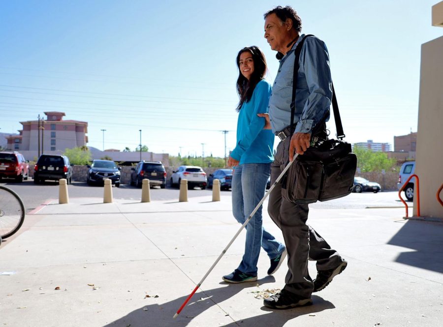 Sophomore Alyson Rodriguez assists UTEP student Almicar Marquez.