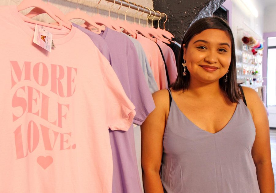 El Pasoan Jacqueline Vigil poses in front of her “More Self Love” shirts, part of the various apparel products she sells as creator of Muchas Flores Studio March 30, 2022. 
