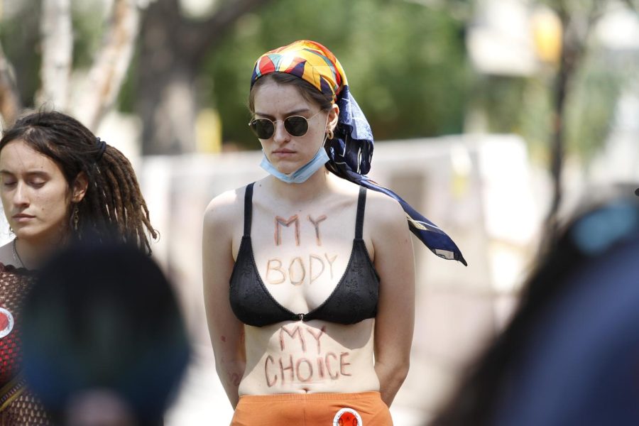 A protestor listens to a speech with the words “my body my choice” written all over her body during a pro abortion protest in downtown El Paso on June 6,2021. 