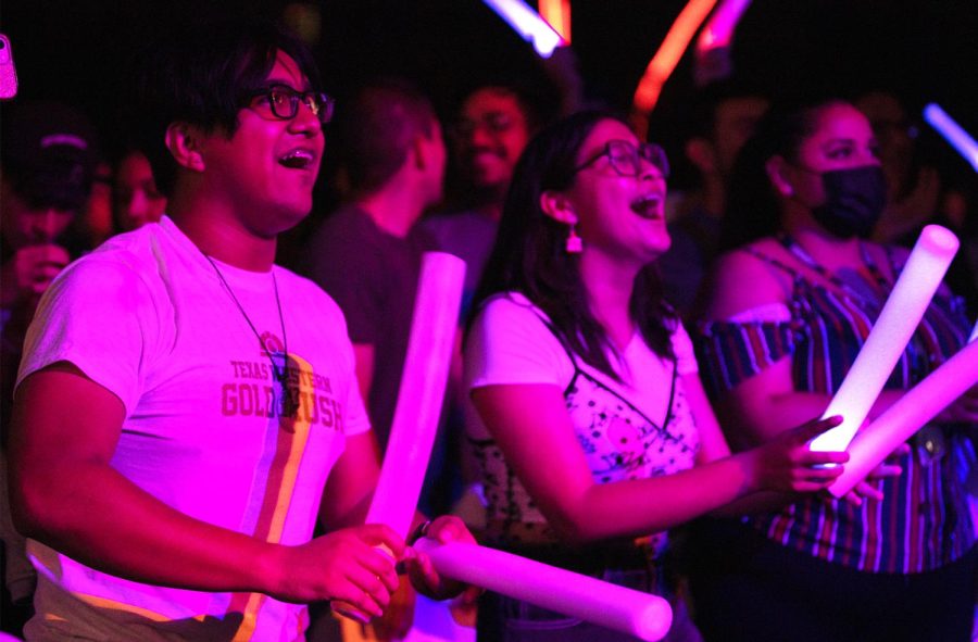 Students in the crowd cheer as Paydirt Pete and cheerleaders dance on stage at Texas Western Gold Rush Aug. 243.