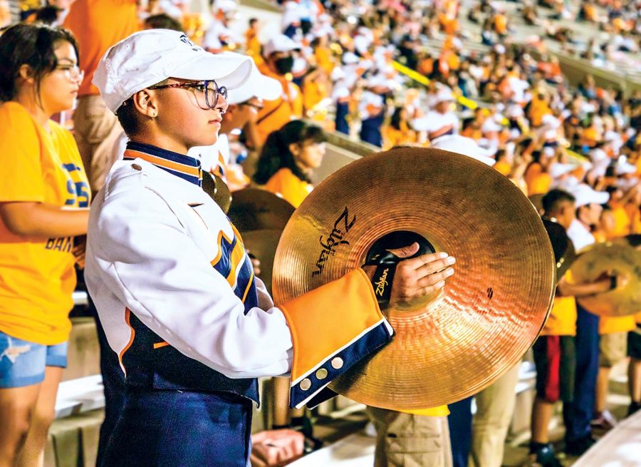 Freshmen Kristan Isaacs plays her cymbals at the UTEP vs UNT football game on Aug. 27, adding color to the sound of the band.  
