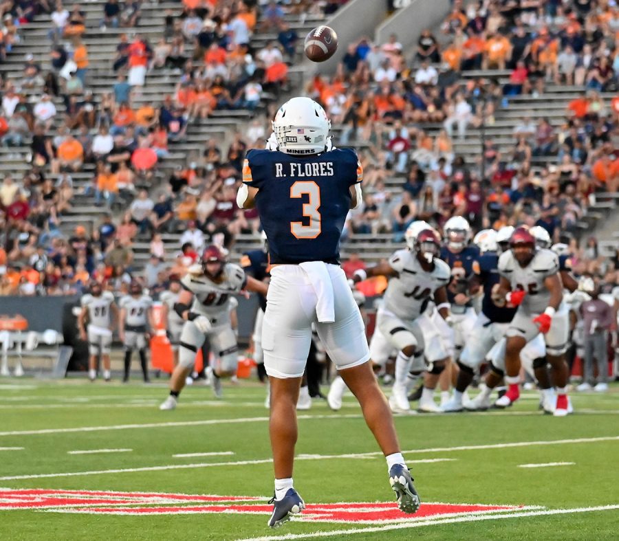 UTEP football running back/wide receiver, Reynaldo Flores, who began his football career at the university as a walk-on, jumps in the air to catch as pass during a game against New Mexico State on Sept. 10. 