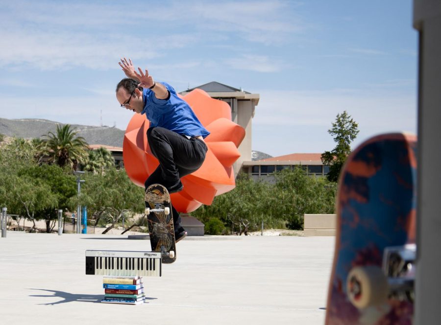 Brian Jarvis, associate professor of music theory at UTEP skates over a keyboard and music textbooks. 