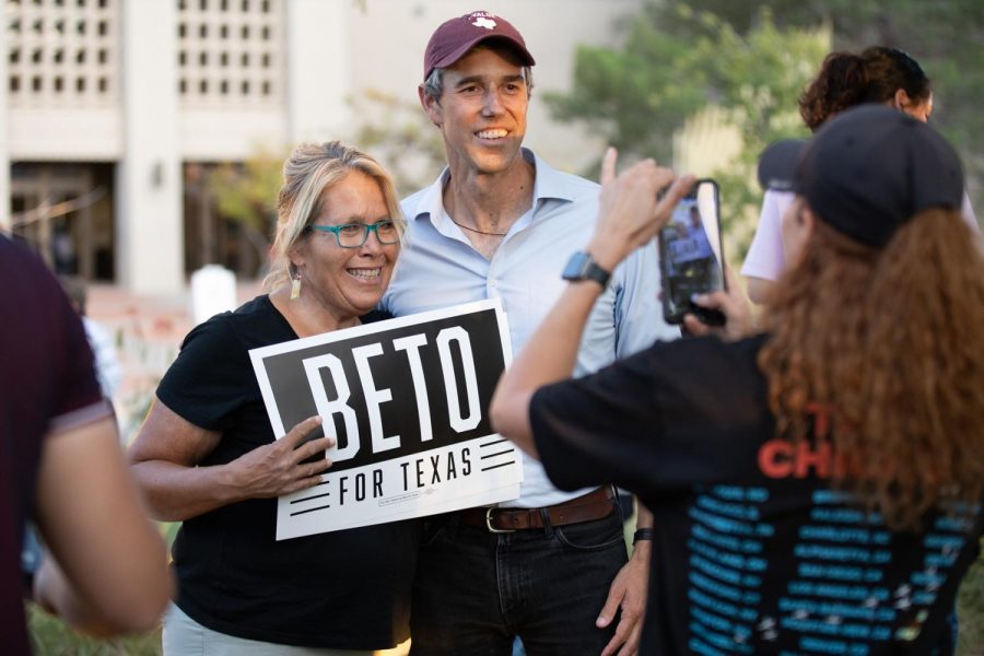 O’Rourke poses with supporter holding a “Beto for Texas” poster, Oct. 11.