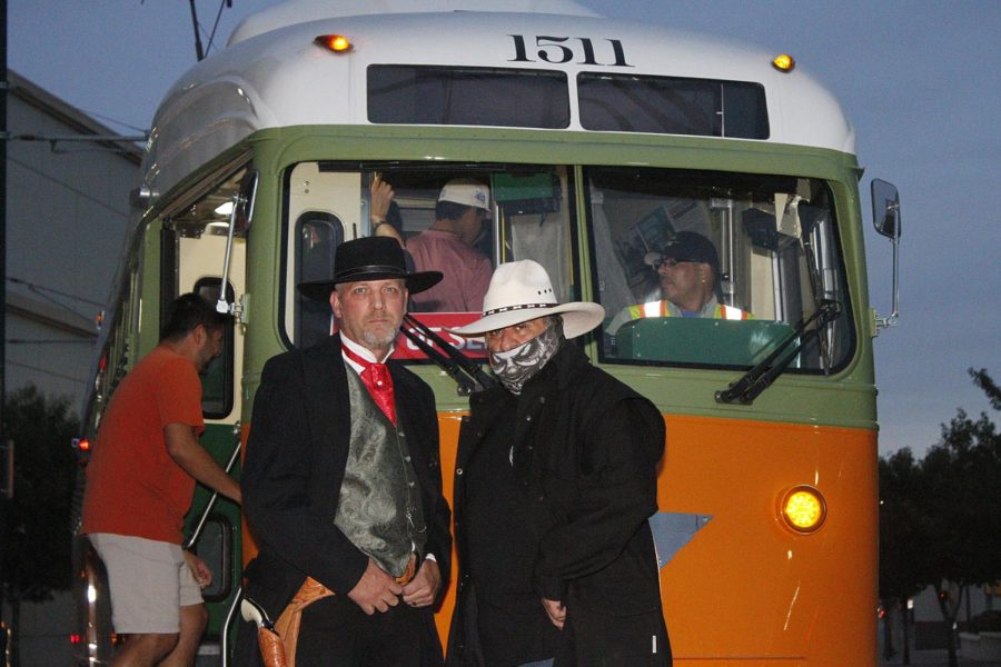 Two men dressed in cowboy attire pose for a picture Oct. 14 before the haunted trolly tour. 
