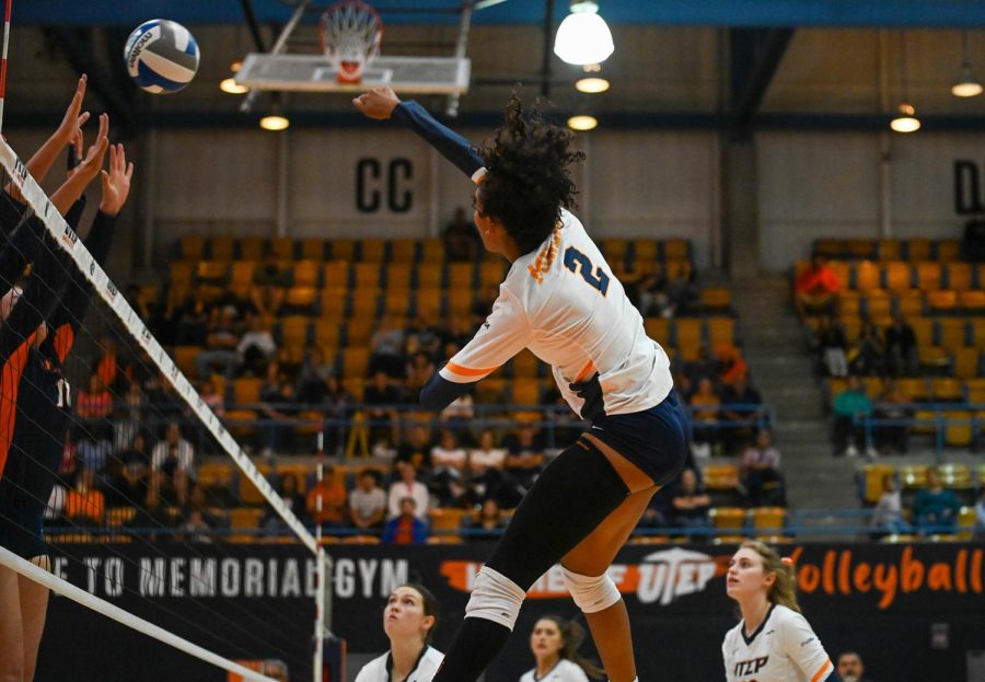 Senior outside/middle blocker, Alianza Darley, jumps up to spike the ball during a set against UTSA.  