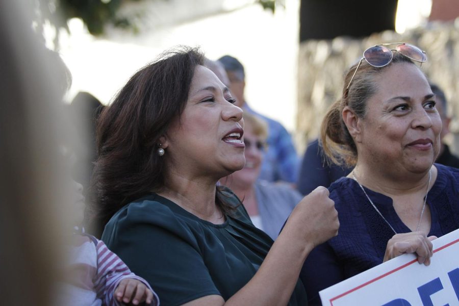 Irene Armendariz Jackson films a video with supporters encouraging others to go vote.