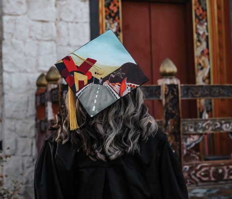 Graduate Lourdes Jimenez decorates her cap to symbolize her journey commuting to and from her campus, and her dedication to earn her degree.  