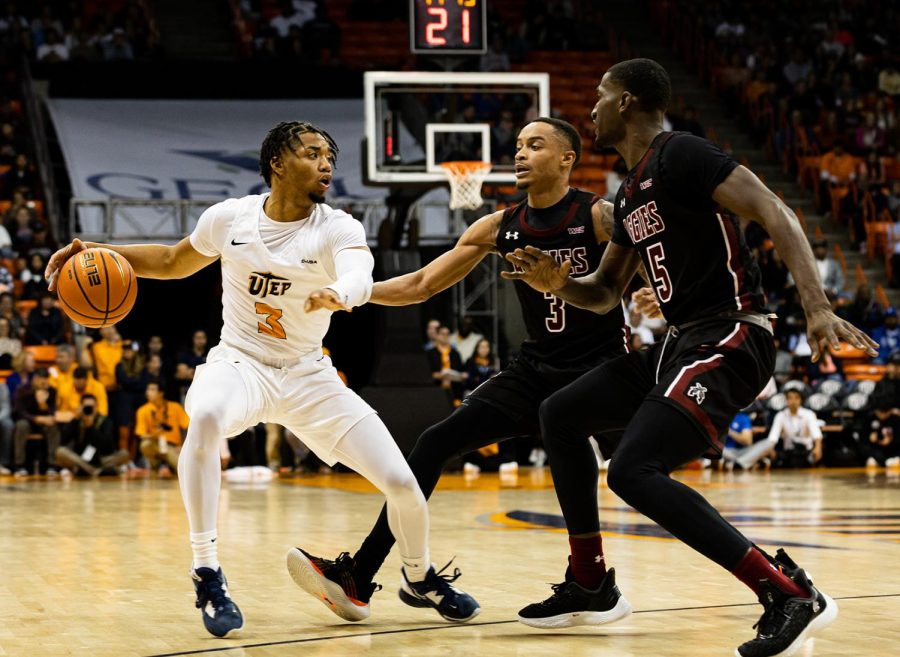 Guard Malik Zachery plays offense against two Aggies players. 