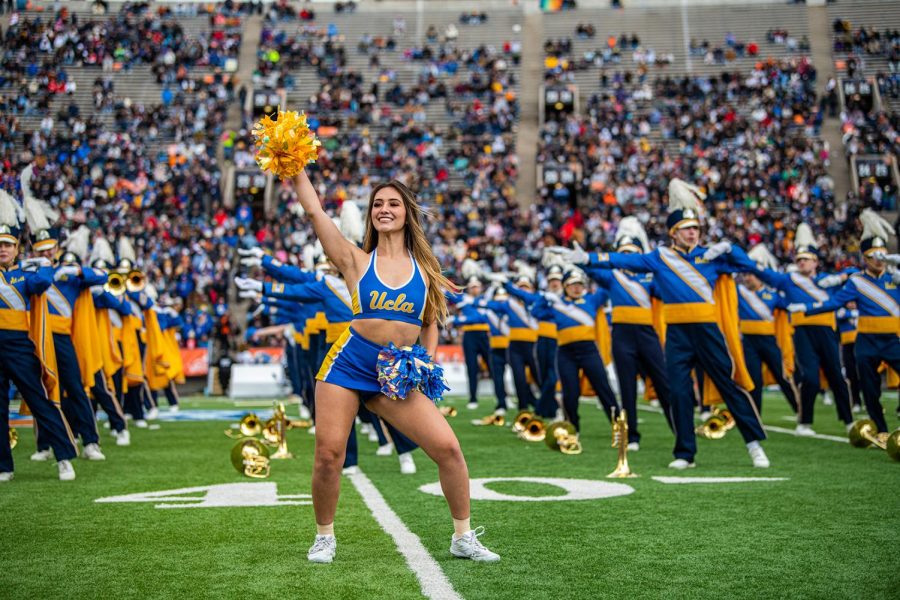 UCLA Cheer Team performs alongside the UCLA Bruin Marching Band.