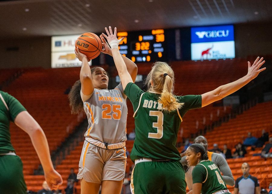 Guard Soleil Montrose prepares to shoot a jump-shot while being closely defended.  