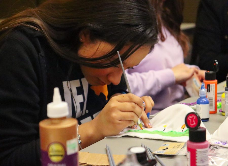 Sorority member upcycles bra at Art your Bra event hosted by Sigma Lambda Gamma National Sorority.