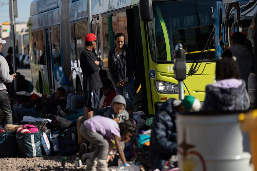 Migrants step off a Sun Metro bus on the corner of Oregon Street and E Father Rahm Avenue. 