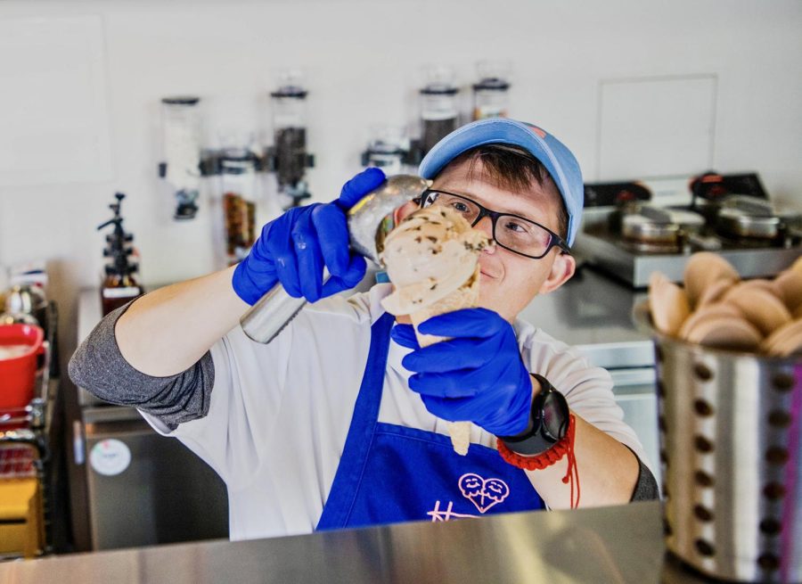 Hero, Evan Vourazeris scoops the Howdy Homemade signature flavor, Dr. Pepper Chocolate Chip. 