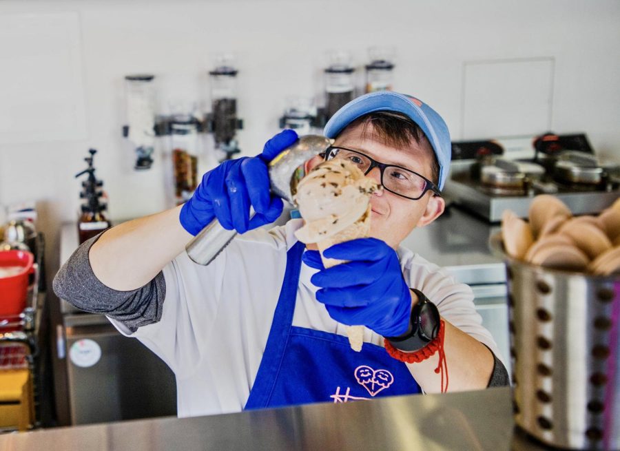 Hero, Evan Vourazeris scoops the Howdy Homemade signature flavor, Dr. Pepper Chocolate Chip.