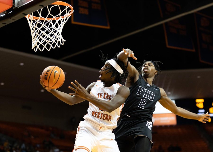 Guard Tae Hardy tries to make a basket against Florida Internation University player. 