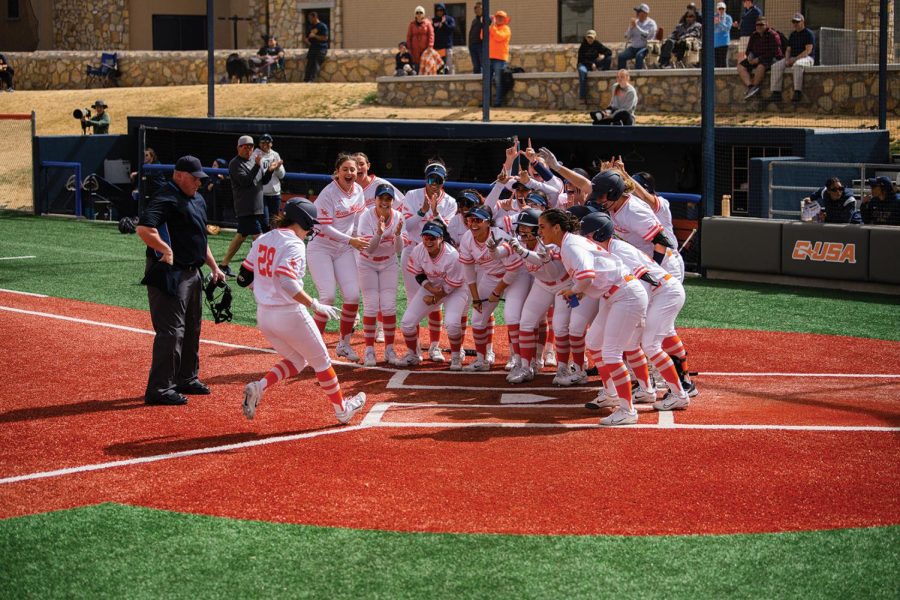 Sophomore infielder Rylan Dooner is met at homeplate by the team to celebrate her homerun against the No. 4 Oklahoma State Cowgirls Sunday, Feb. 28 for the UTEP Softball Invitational at the Helen of Troy Softball Complex. 