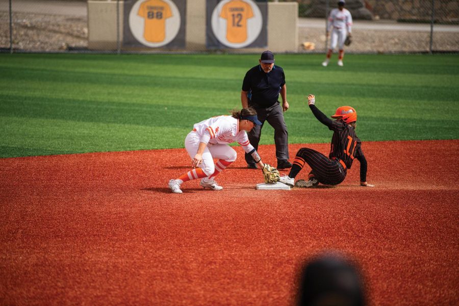 Rylan Dooner applies a tag at second base in attempt to throw the runner out 
