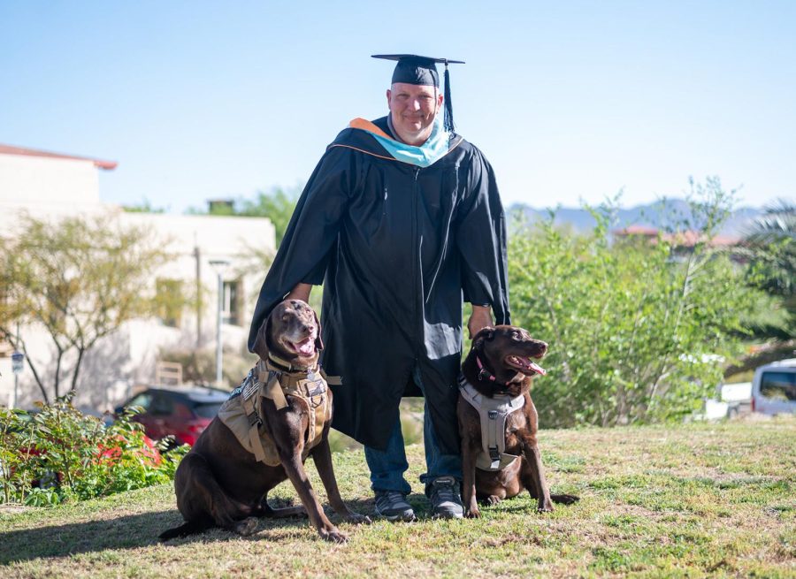 Upcoming UTEP graduate Daniel Shiprak and his service dogs, Buddha and Daisy Mae, come together and pose for a photo.