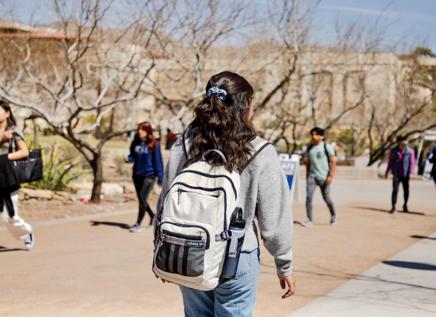 Students walk to their first class by Centennial Park to prepare for the school day.  