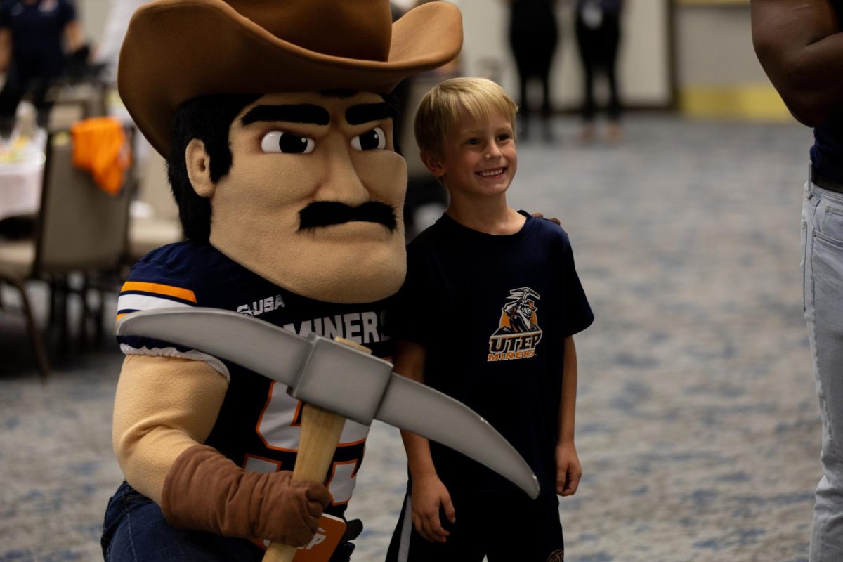 Attendee poses with Paydirt Pete at the annual football luncheon, July 26.  
