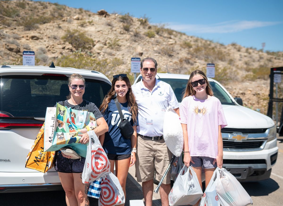 Freshman beach volleyball player, Sophia Sheppard (pictured in the blue UTEP shirt) poses for a photo with her family before moving into Miner Village.  
