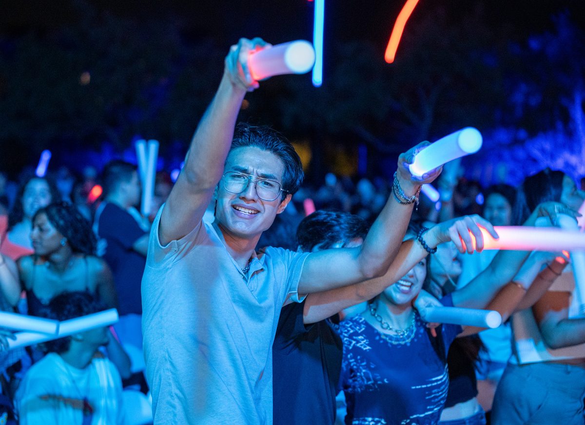 Attendee points his glow-sticks towards the camera.  