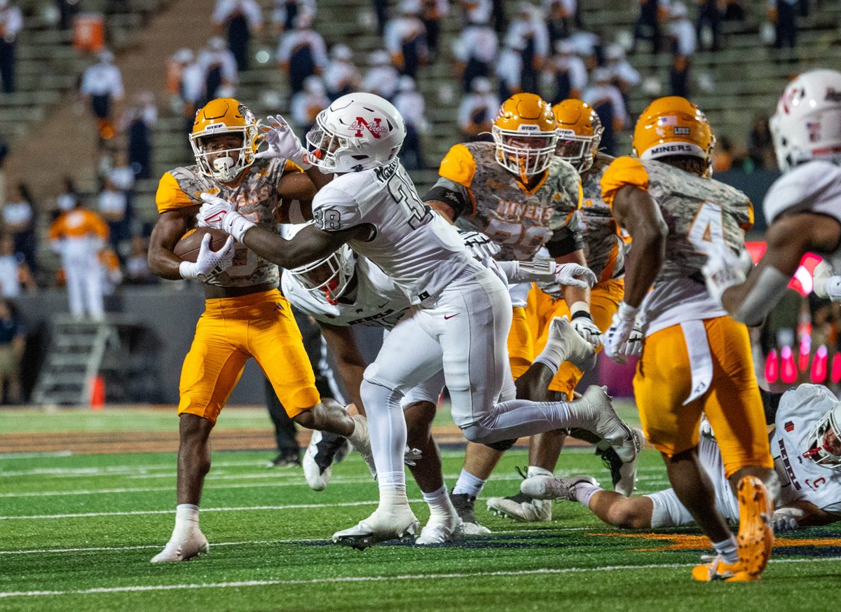 Running back Torrance Burgess Jr. carries the ball amongst several defenders from UNLV. 