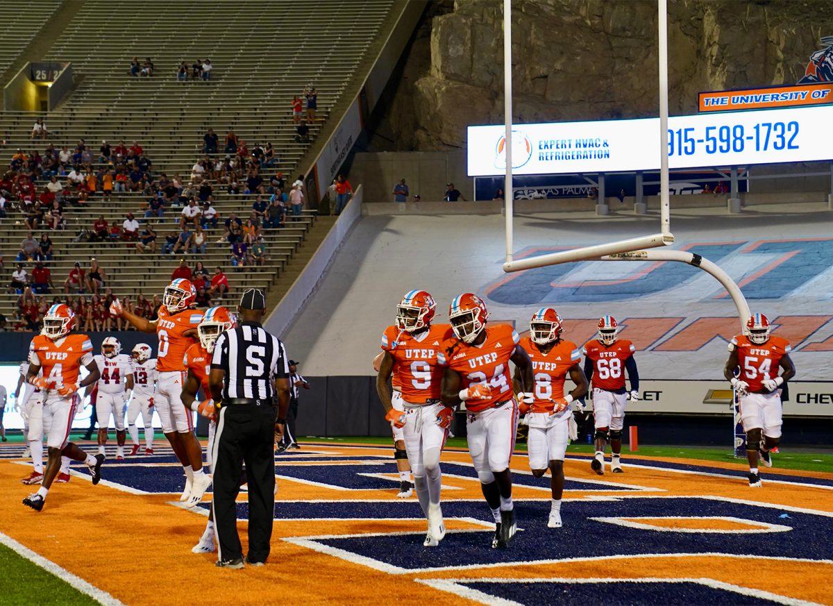 UTEP football players headed back to the sidelines mid celebration after scoring a touchdown.